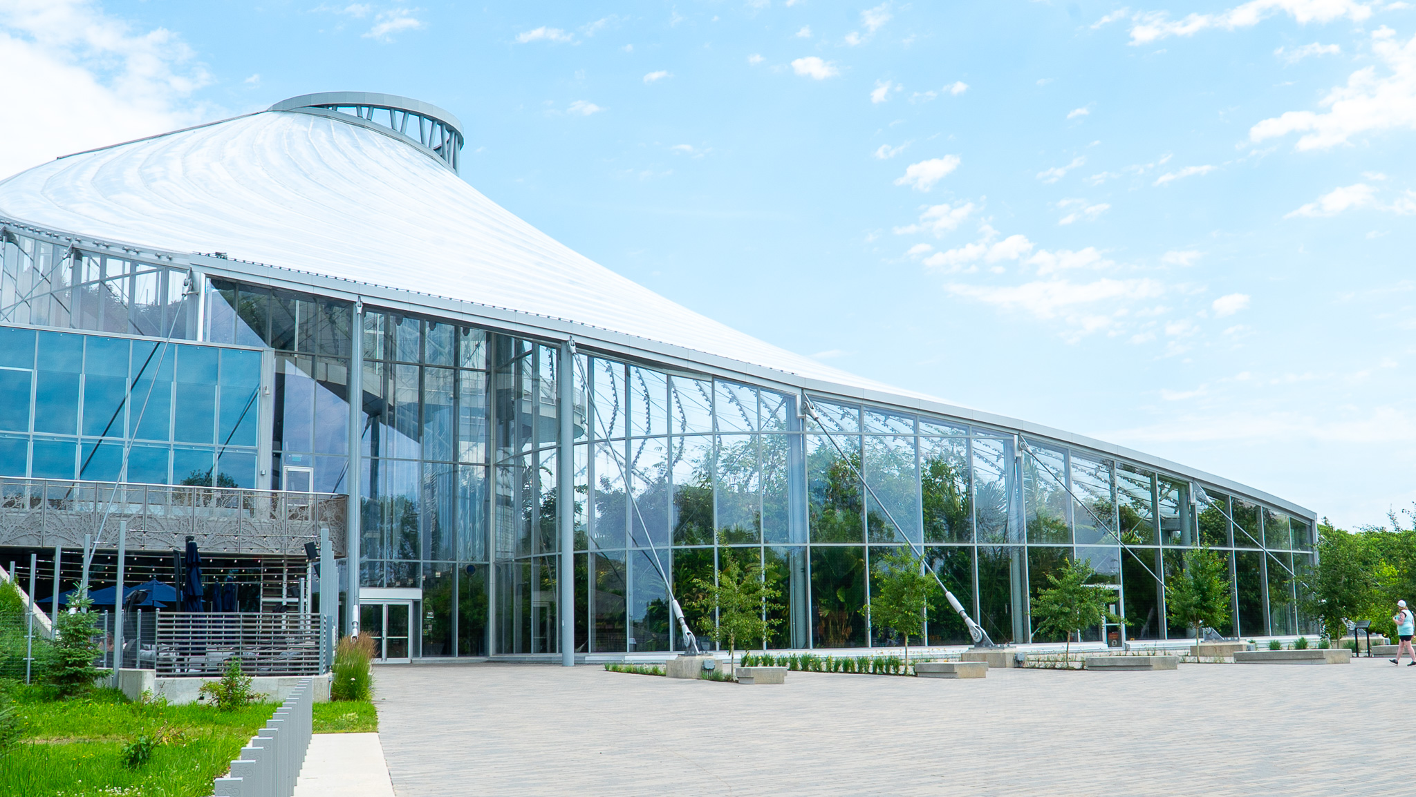 The curved glass and white canopy exterior of The Leaf at Assiniboine Park