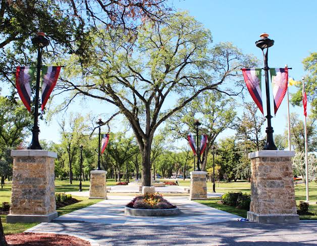 Stone pillars and banner-lined walkway at the entrance to Vimy Ridge Memorial Park